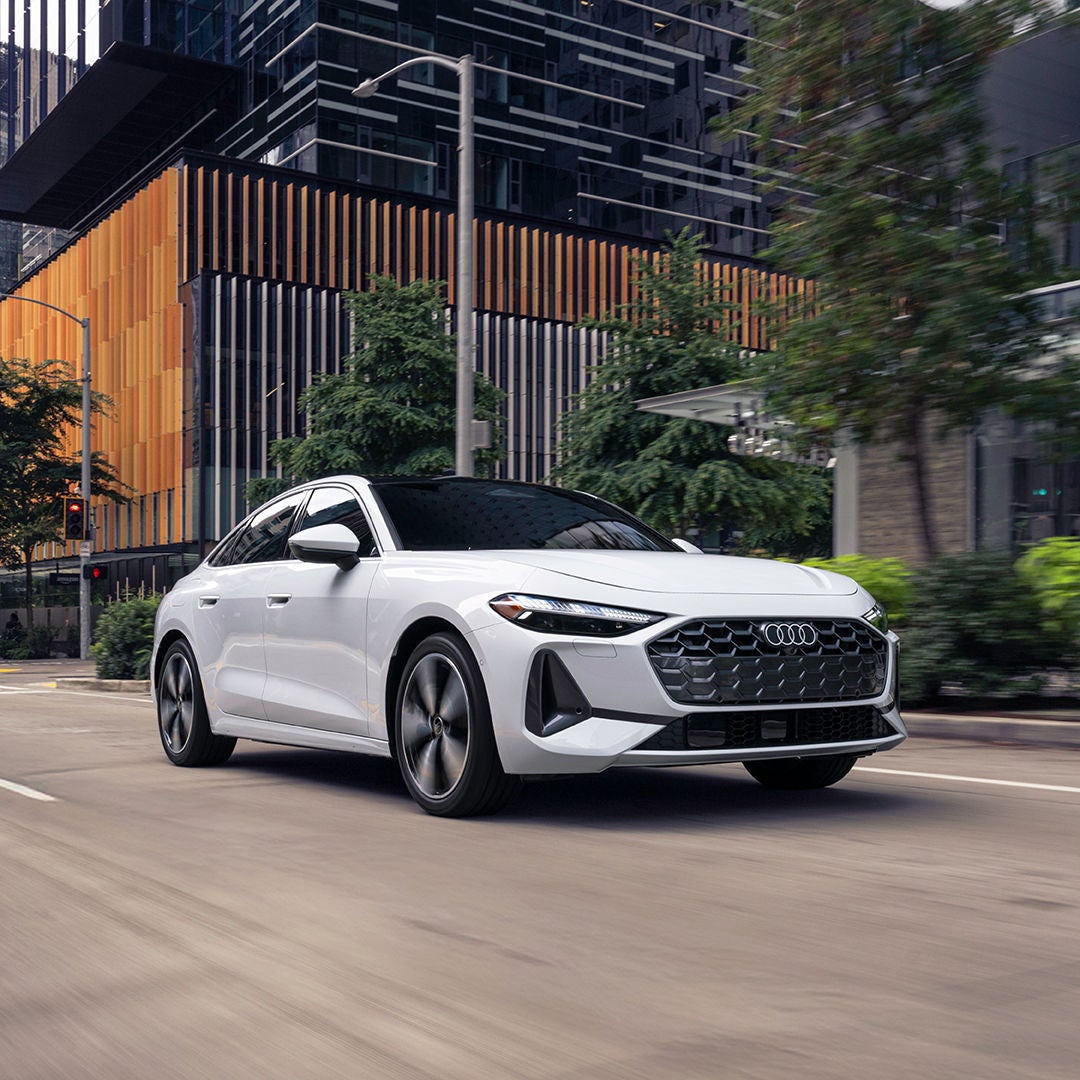 Left side profile view of an Audi A5 accelerating. 